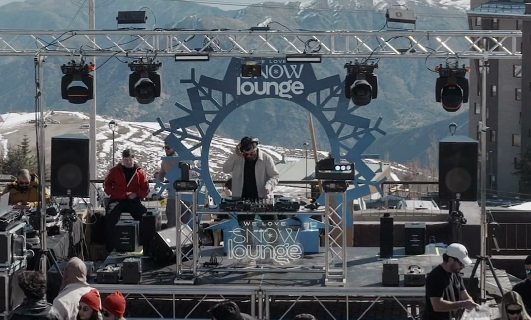 Cabine de DJ tocando de dia para a multidão na We Love Snow Lounge.